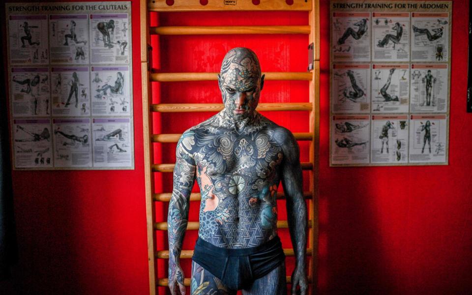 Mr Helaine says that getting tattoos is his passion - CHRISTOPHE ARCHAMBAULT /AFP