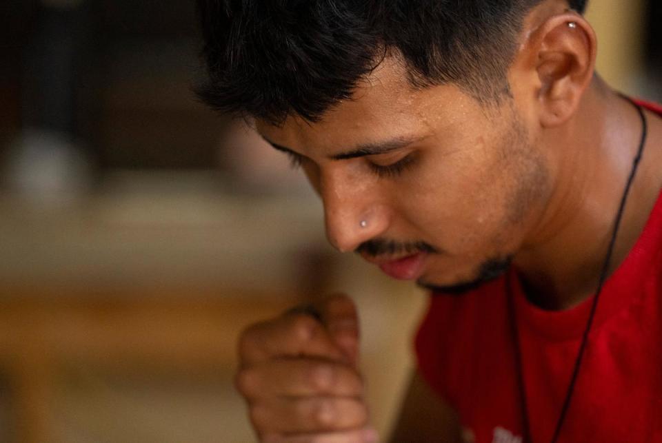 Johnny Barcenas, 24, sweats while working on renovating the floor of a home with Juan Pedro Muñoz and their crew in Austin on July 7, 2023.