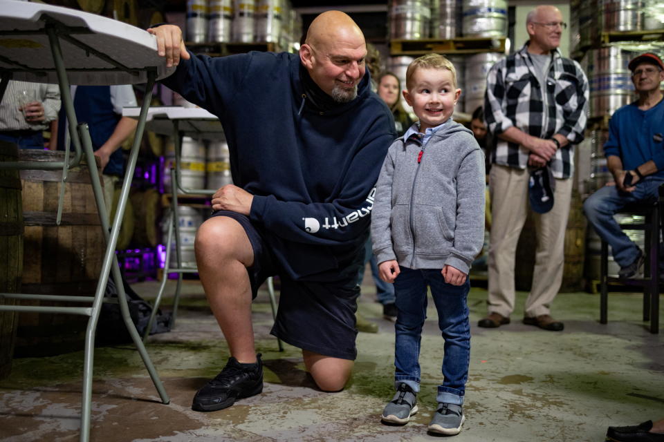 Lt. Gov. John Fetterman poses for a photo with 4-year-old Ryan Dow at a candidate event in Easton, Pa., on May 1.