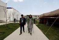 Rahmatullah Amiri, (R) a political science student of American University of Afghanistan who was injured in last year's attack, arrives for new orientation sessions at a American University in Kabul, Afghanistan March 27, 2017.REUTERS/Mohammad Ismail