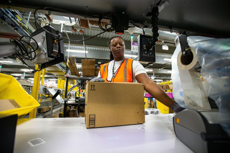 An Amazon employee packages items to be shipped to customers in the Tallahassee Amazon facility on Wednesday, Sept. 13, 2023.