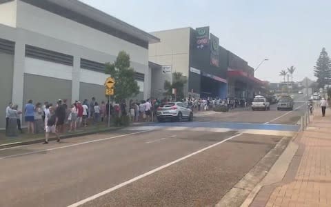 A long queue forms at a Woolworths supermarket in Ulladulla, New South Wales