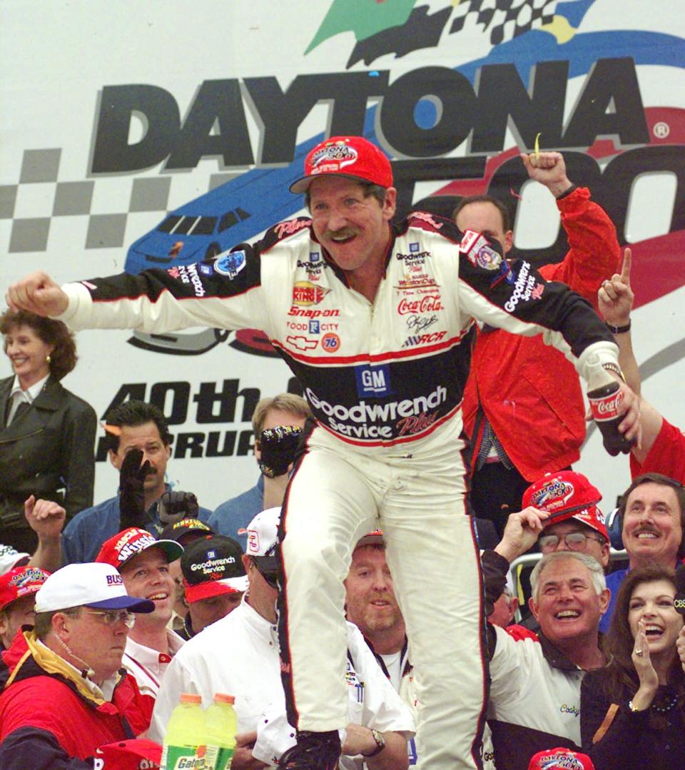 Earnhardt climbs to the roof of his winning car in 1998 after finally reaching a Daytona 500 Victory Lane.