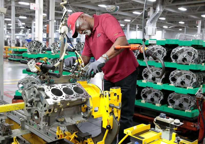 A General Motors assembly worker works on assembling a V6 engine, used in a variety of GM cars, trucks and crossovers, at the GM Romulus Powertrain plant in Romulus,