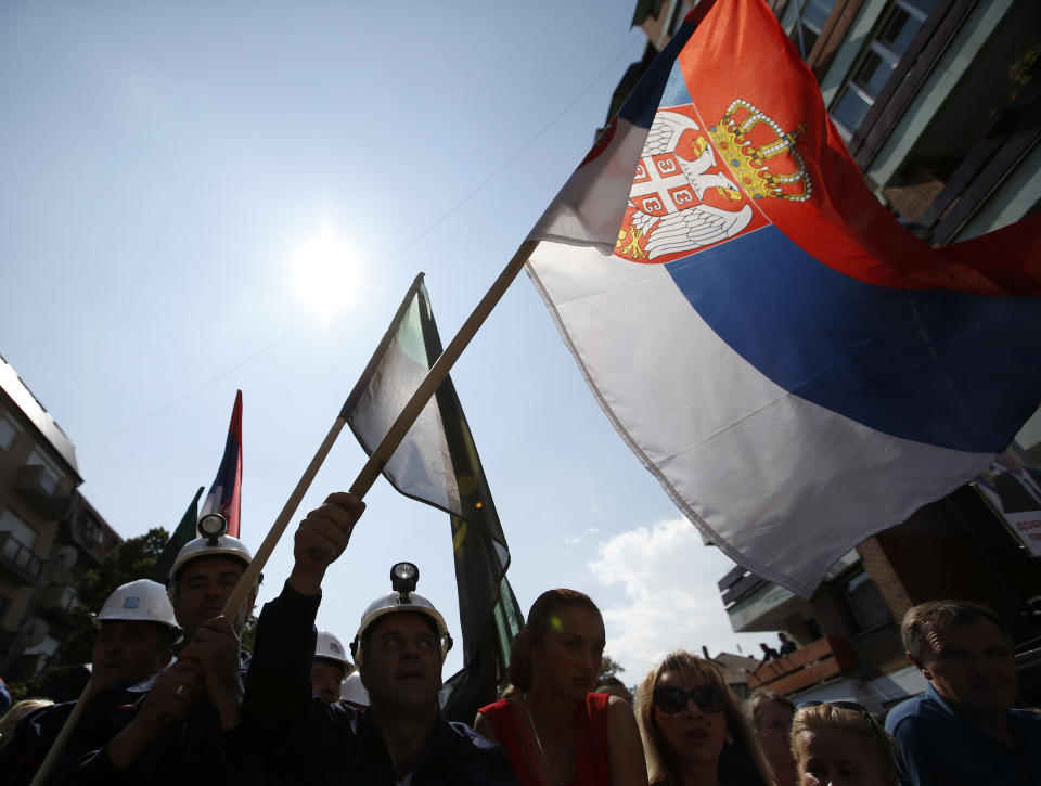 A Kosovo Serb waves a Serbian flag during a rally of Serbian President Aleksandar Vucic in the northern, Serb-dominated part of Mitrovica, Kosovo, Sunday, Sept. 9, 2018. NATO-led peacekeepers in Kosovo say the safety of Serbia President Aleksandar Vucic during a visit to Kosovo isn't threatened despite roadblocks that prevented his visit to a central Serb-populated village. (AP Photo/Darko Vojinovic)