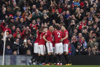 Manchester United's team players celebrate after Anthony Martial scored the opening goal during the English Premier League soccer match between Manchester United and Manchester City at Old Trafford in Manchester, England, Sunday, March 8, 2020. (AP Photo/Dave Thompson)