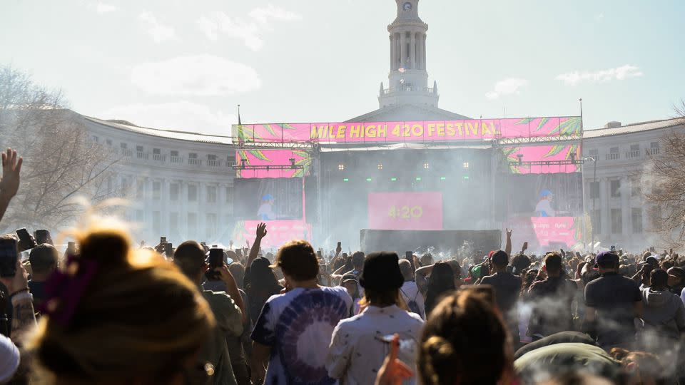 A cloud of marijuana smoke rises as a clock hits 4:20 p.m. during the Mile High 420 Festival in Denver on "weed day" in 2022. - Patrick T. Fallon/AFP/Getty Images/File