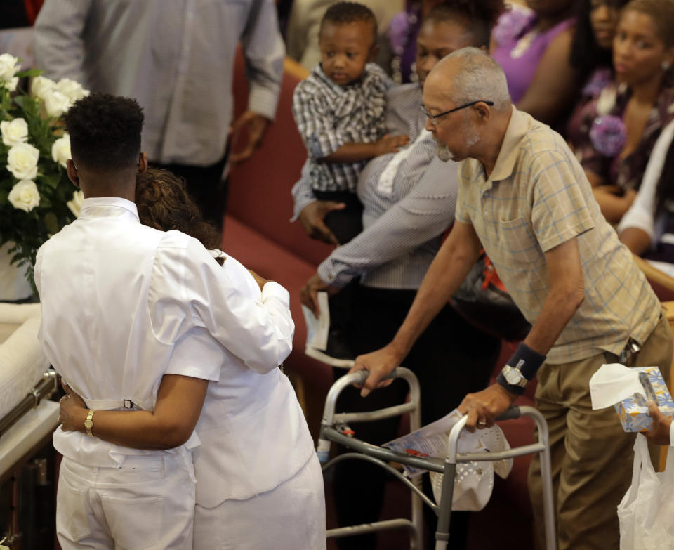 Guest comfort each other during services for Glenn Coleman, Reece Coleman, Evan Coleman and Arya Coleman, Friday, July 27, 2018, in Indianapolis. Nine members of the Coleman family were killed after a duck boat capsized and sank during a storm in Branson, Mo. (AP Photo/Darron Cummings)