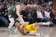 Indiana Pacers' T.J. McConnell (9) is defended by Milwaukee Bucks' Grayson Allen (12) during the second half of an NBA basketball game, Friday, Jan. 27, 2023, in Indianapolis. (AP Photo/Darron Cummings)