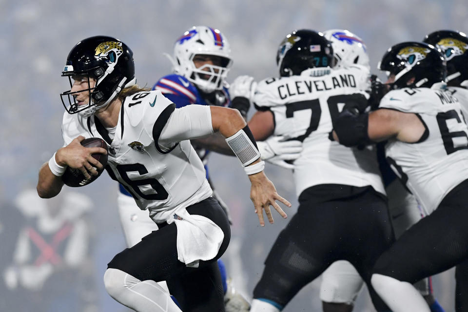 Jacksonville Jaguars quarterback Trevor Lawrence (16) runs out of the pocket during the first half of an NFL football game against the Buffalo Bills, Monday, Sept. 23, 2024, in Orchard Park, NY. (AP Photo/Adrian Kraus)