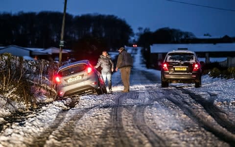 A car in snowy conditions near Snowden Hill in Sheffield, - Credit: Danny Lawson /PA