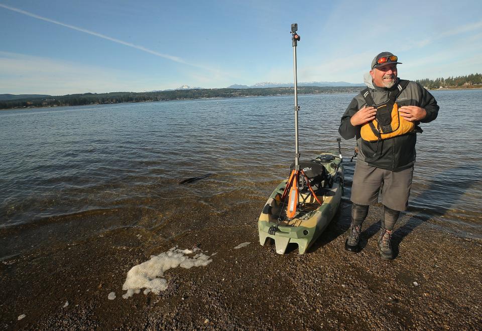 Brian Footen, co-founder and president of EarthViews, dons his life jacket as he prepares to launch his kayak at the Tracyton Boat Launch on Wednesday.