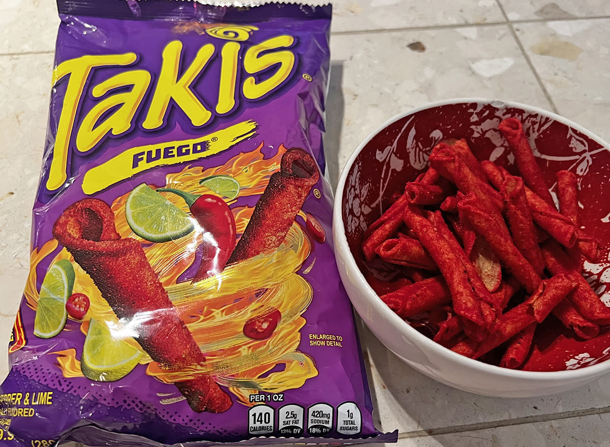 takis fuego rolled tortilla chips in a bag and a bowl.