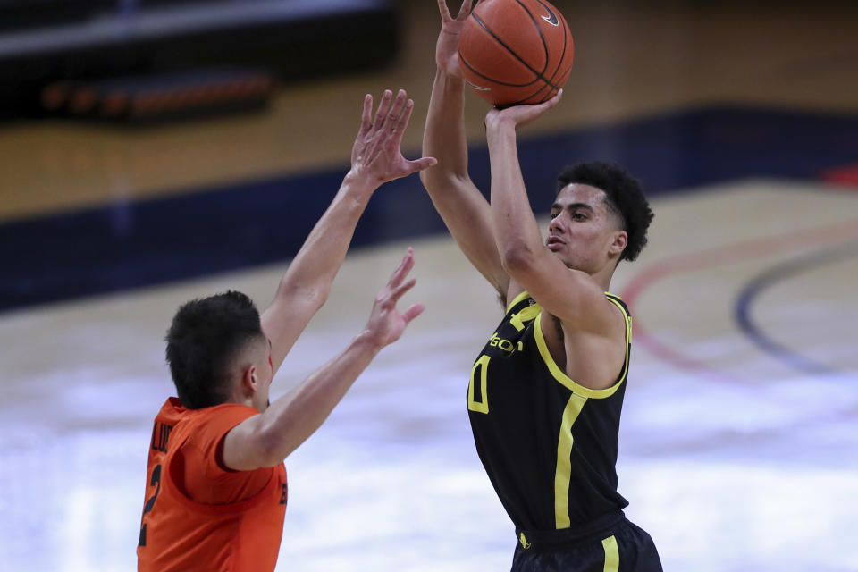 Oregon's Will Richardson (0) shoots over Oregon State's Jarod Lucas (2) during the second half of an NCAA college basketball game in Corvallis, Ore., Sunday, March 7, 2021. (AP Photo/Amanda Loman)