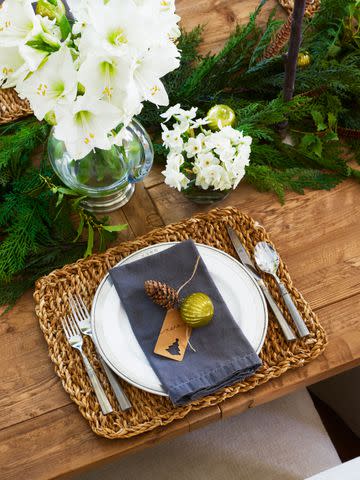 <p>James Ransom</p> Woven place mats and cloth napkins bring texture to the table, where each spot is set with an ornament on its place card.