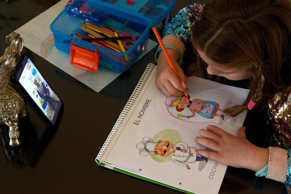 TOPSHOT - A six-year-old Spanish girl studies while watching a video of her teacher Almudena in Sevilla on April 14, 2020 amid a national lockdown to stop the spread of the COVID-19 coronavirus. - Spain's death toll from the novel coronavirus topped 18,000, as the rise in new infections dropped to its lowest level since the country imposed a nationwide lockdown last month. (Photo by CRISTINA QUICLER / AFP) (Photo by CRISTINA QUICLER/AFP via Getty Images)