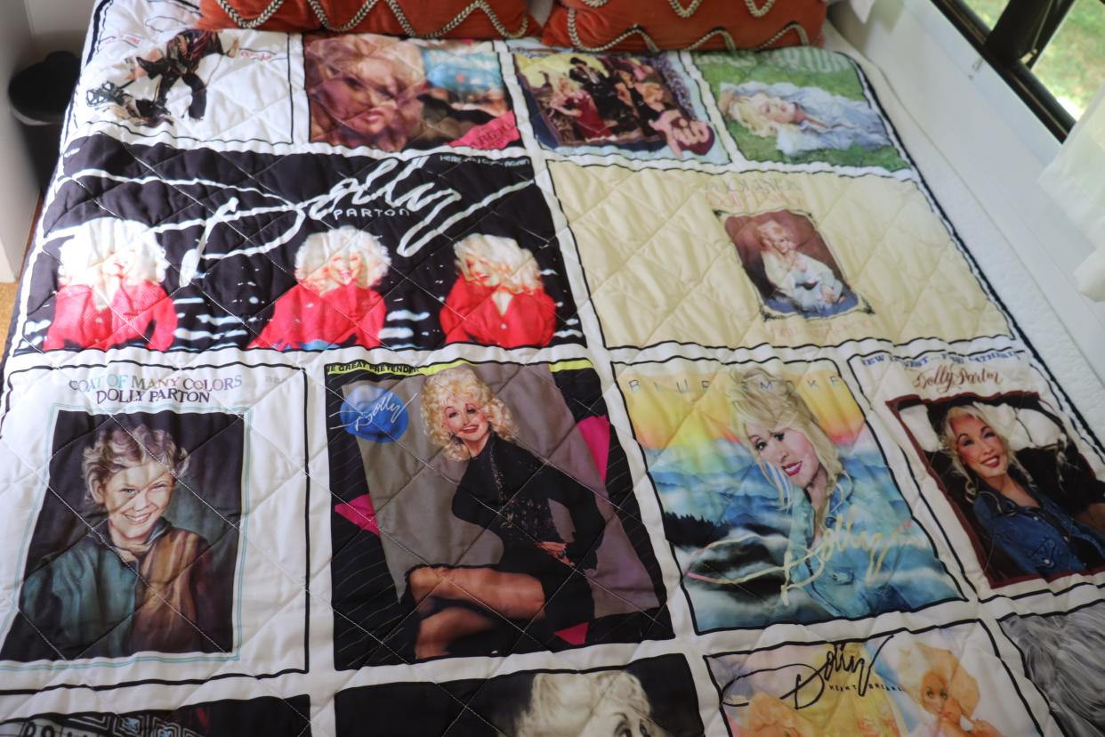 A quilt printed with Dolly Parton albums