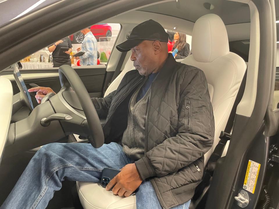 Norwich resident and Tesla owner Joel Collins looks at the Tesla Model Y Performance on display at the new Tesla showroom at Mohegan Sun, which opened Wednesday.