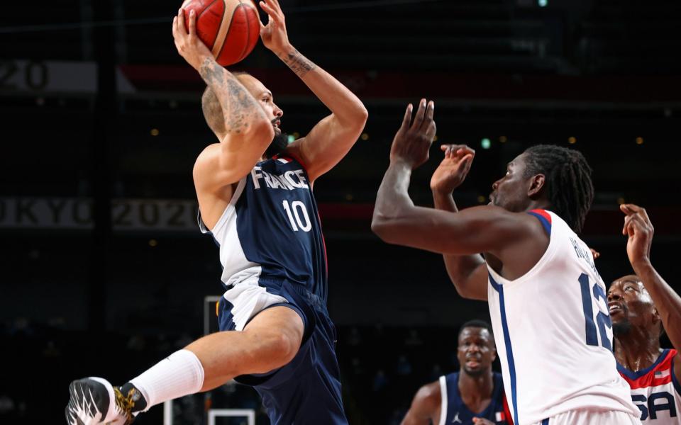 Saitama Super Arena, Saitama, Japan - August 7, 2021. Evan Fournier of France in action with Jrue Holiday of the United States. - REUTERS/Brian Snyder