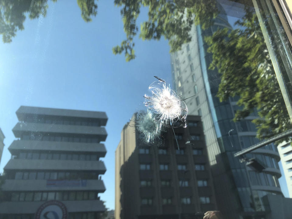 The damage to a security booth by a shot fired, is seen outside the U.S. Embassy in Ankara, Turkey, Monday, Aug. 20, 2018. Shots were fired at a security booth outside the embassy in Turkey's capital early Monday, but U.S. officials said no one was hurt. Ties between Ankara and Washington have been strained over the case of an imprisoned American pastor, leading the U.S. to impose sanctions, and increased tariffs that sent the Turkish lira tumbling last week. (AP Photo/Burhan Ozbilici)