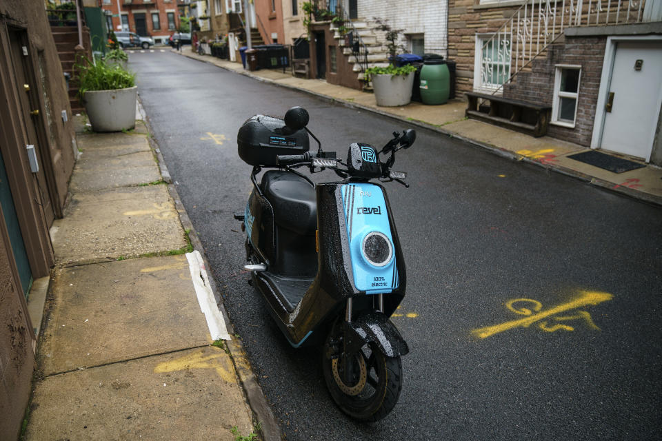 NEW YORK, NY - JUNE 18: A Revel brand moped sits parked on a residential street, June 18, 2019 in the Brooklyn borough of New York City. The ride-share moped company has deployed over 1,000 electric mopeds through Brooklyn and Queens. The fully electric mopeds top out at 30 miles per hour and are available to rent by the minute via smartphone. (Photo by Drew Angerer/Getty Images)