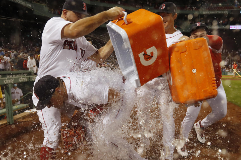 Boston Red Sox dump water onto Hunter Renfroe after their 2-1 win over the Tampa Bay Rays in a baseball game Wednesday, Sept. 8, 2021, at Fenway Park in Boston. Renfroe hit a two-run home run in the eighth and threw out a runner at third to end the game. (AP Photo/Winslow Townson)