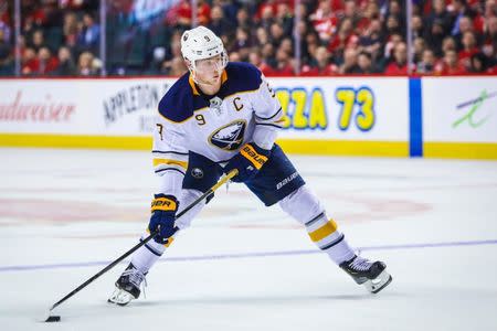 Jan 16, 2019; Calgary, Alberta, CAN; Buffalo Sabres center Jack Eichel (9) controls the puck against the Calgary Flames during the overtime period at Scotiabank Saddledome. Mandatory Credit: Sergei Belski-USA TODAY Sports