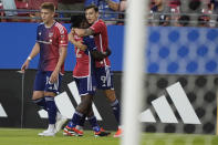 FC Dallas forward Petar Musa (9) celebrates after his goal with teammates Ema Twumasi, center, and Liam Fraser (18) during the first half of an MLS soccer match against Austin FC, Saturday, May 11, 2024, in Frisco, Texas. (AP Photo/LM Otero)