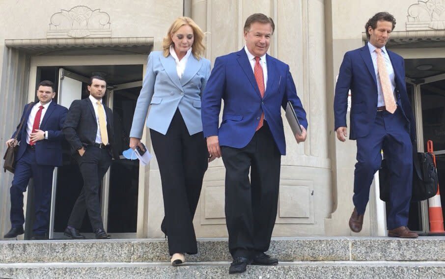 Patricia McCloskey, left, and her husband Mark McCloskey walk out of the Carnahan Courthouse in downtown St. Louis on Thursday, June 17, 2021, with their lawyer Joel Schwartz, right. The St. Louis couple who gained notoriety for pointing guns at social justice demonstrators last year pleaded guilty Thursday to misdemeanor charges and agreed to give up the weapons they used during the confrontation. (Joel Currier/St. Louis Post-Dispatch via AP)