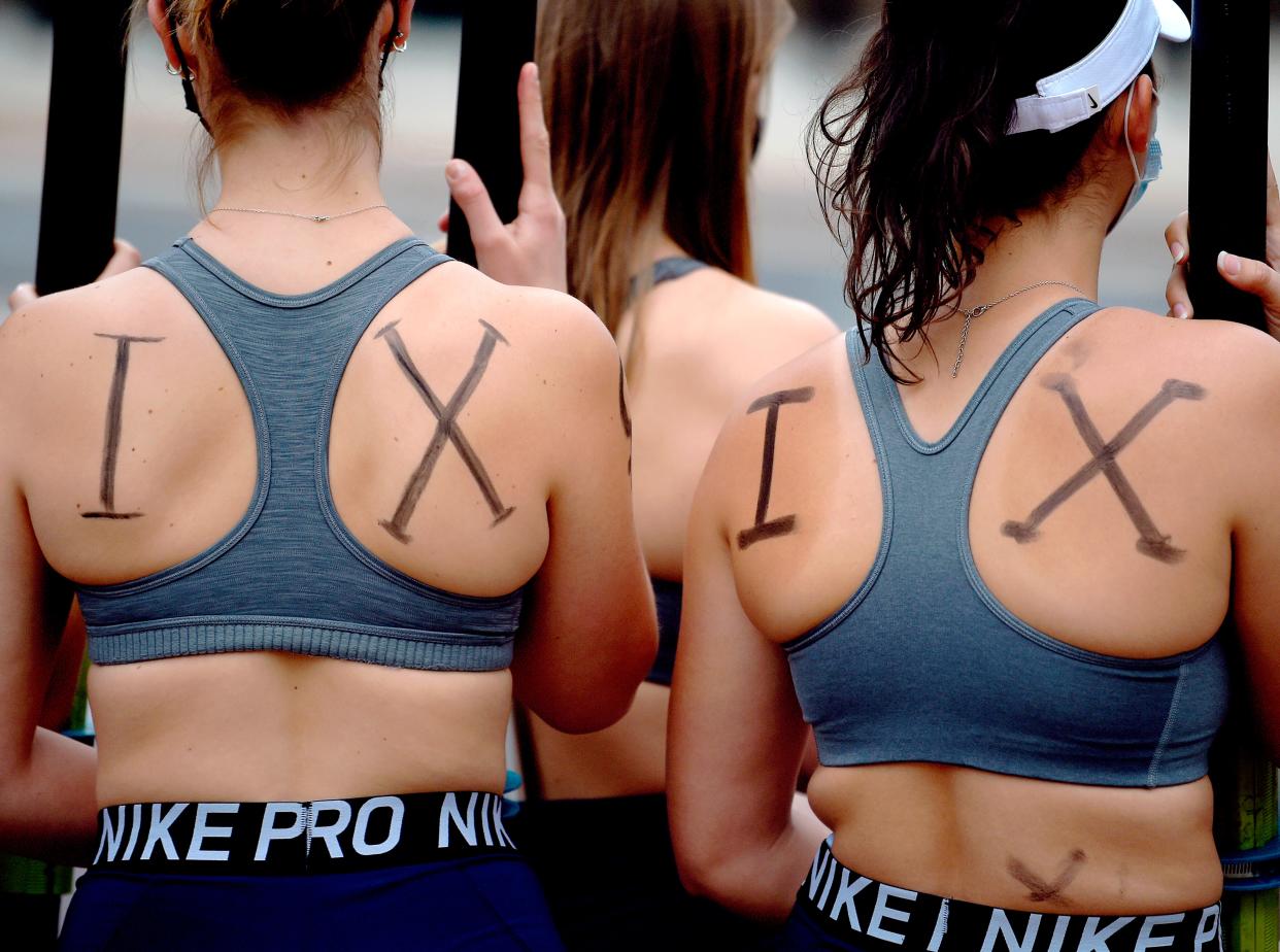Members of the University of Connecticut women's rowing team rally about being cut by the university after the season, in Storrs, Conn., in 2021.