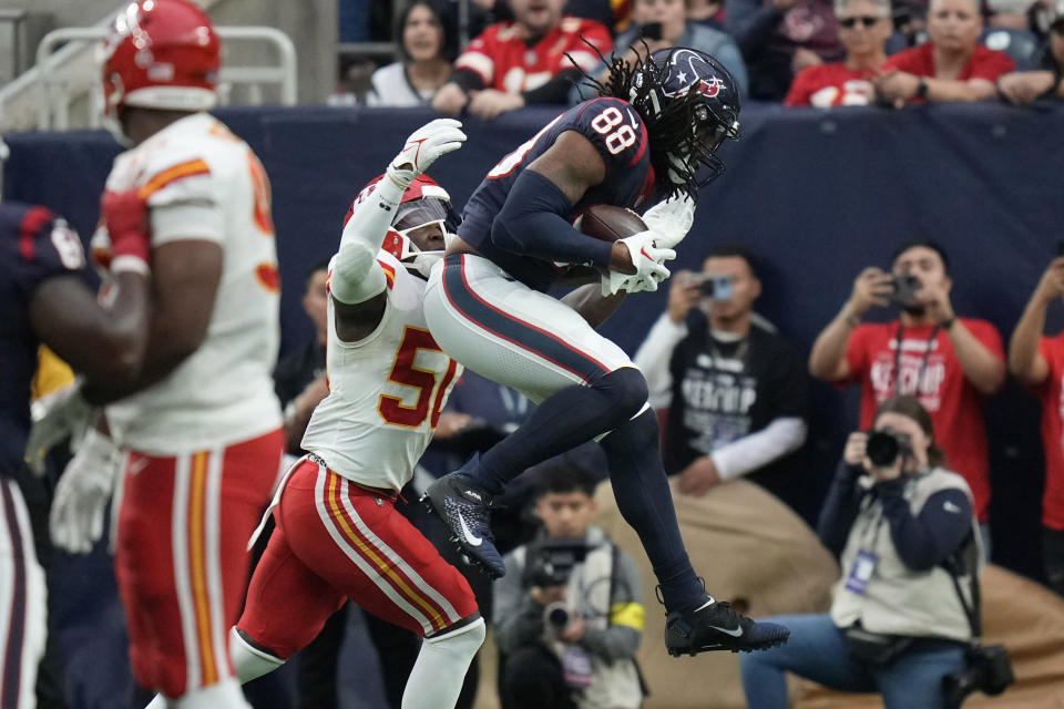 Houston Texans tight end Jordan Akins (88) catches a pass for a touchdown over Kansas City Chiefs linebacker Willie Gay (50) during the second half of an NFL football game Sunday, Dec. 18, 2022, in Houston. (AP Photo/Eric Christian Smith)