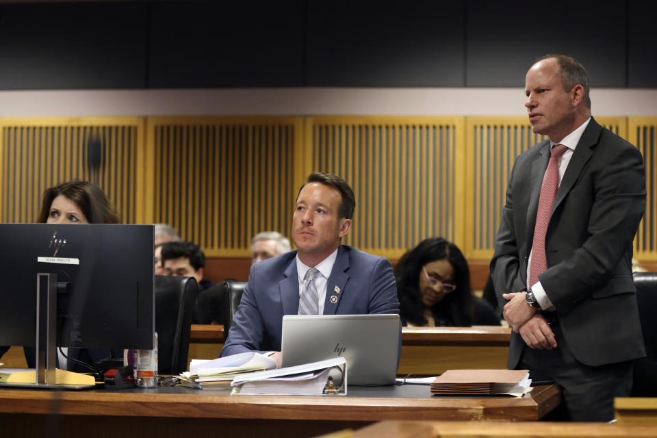 Attorney Andrew Evans, right, who represents Nathan Wade, objects to a question posed to witness Terrence Bradley, Nathan Wade’s former business partner, during a hearing on the Georgia election interference case, Friday, Feb. 16, 2024, in Atlanta. The hearing is to determine whether Fulton County District Attorney Fani Willis should be removed from the case because of a relationship with Wade, special prosecutor, she hired in the election interference case against former President Donald Trump. (Alyssa Pointer/Pool Photo via AP)