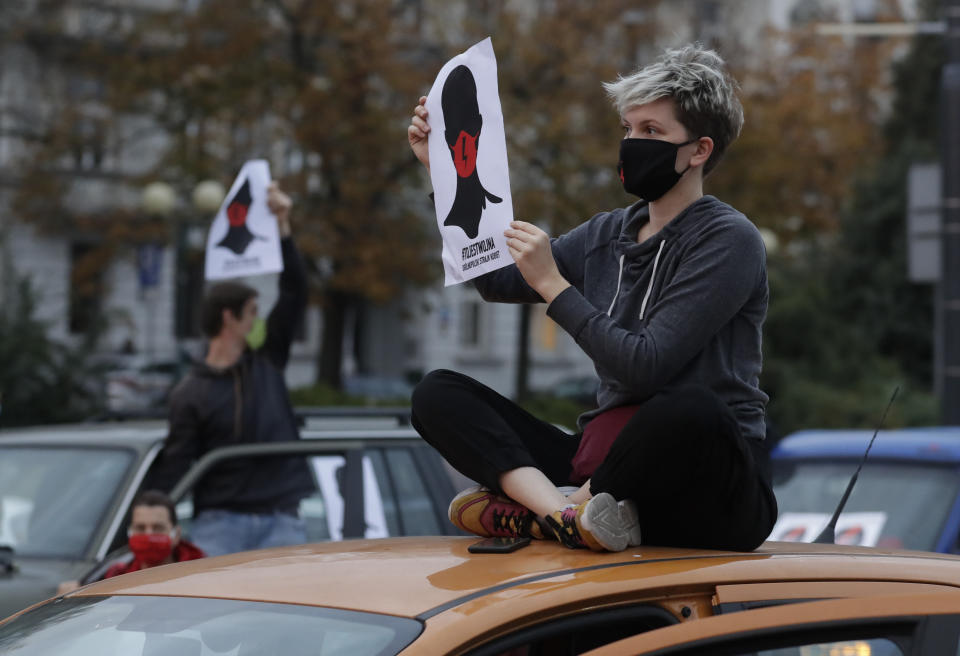 Angered women's rights activists and their supporters block rush-hour traffic at a major roundabout on the fifth day of nationwide protests against recent court ruling that tightened further Poland's restrictive abortion law, in Warsaw, Poland, on Monday, Oct. 26, 2020. The court effectively banned almost all abortions. (AP Photo/Czarek Sokolowski)