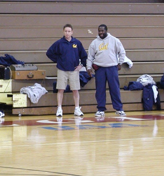 Dr. Joe Carr (right) stands next to California men's basketball coach Ben Braun (left) during a practice.