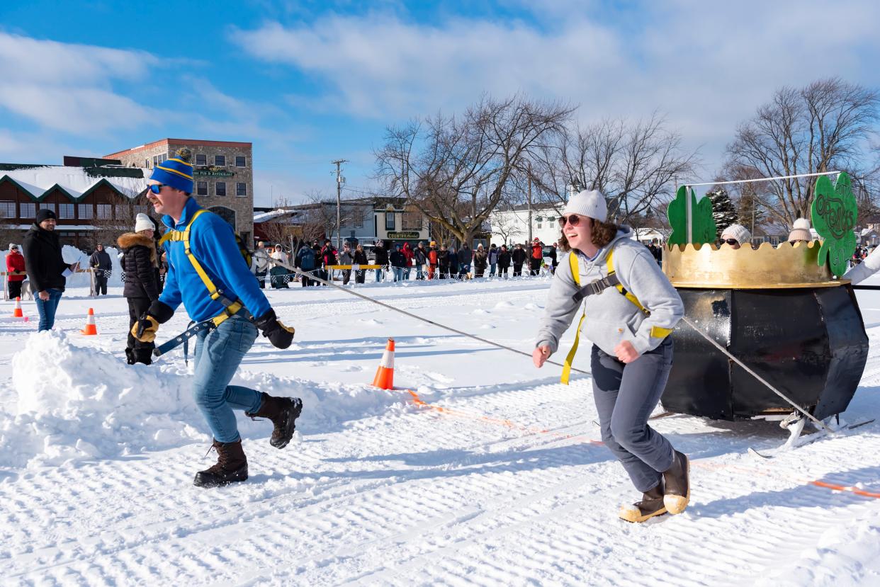 Team O'Reilly's Pub and Restaurant crosses the finish line during the annual Outhouse Races as part of the Mackinaw City Winterfest in the Shepler's Ferry parking lot on Saturday, Jan. 20, 2024.