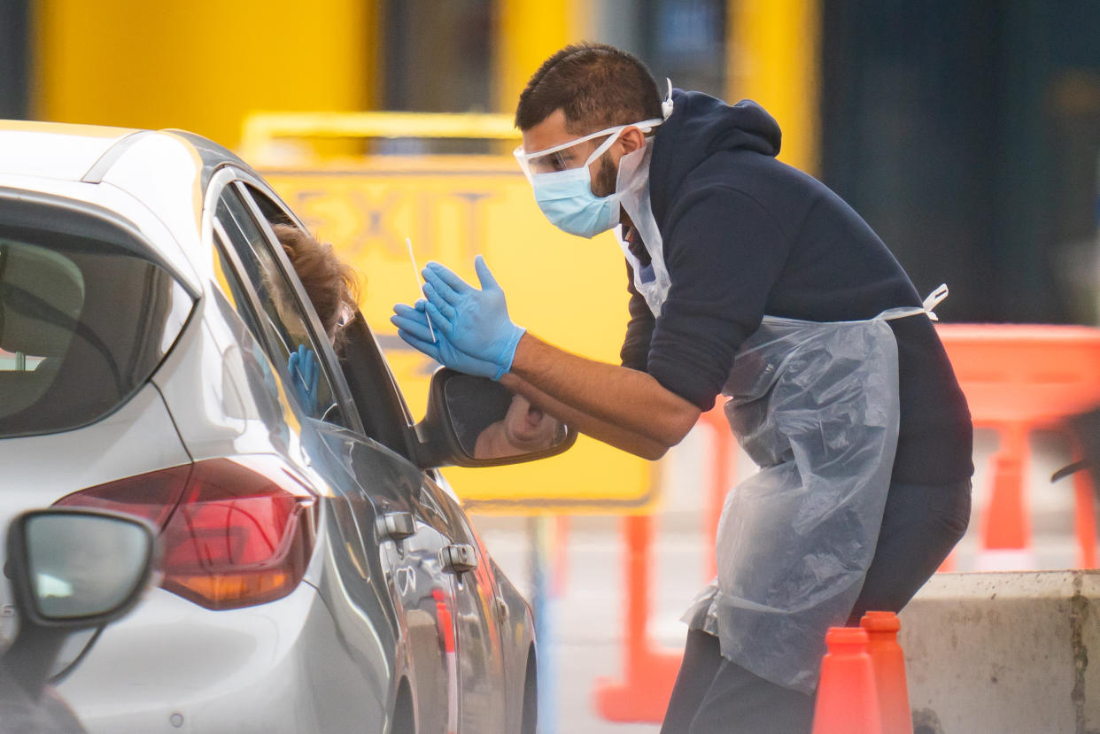 Photo taken at 10:56am of medical staff at an NHS drive through coronavirus disease (COVID-19) testing facility in an IKEA car park, Wembley as the UK continues in lockdown to help curb the spread of the coronavirus.