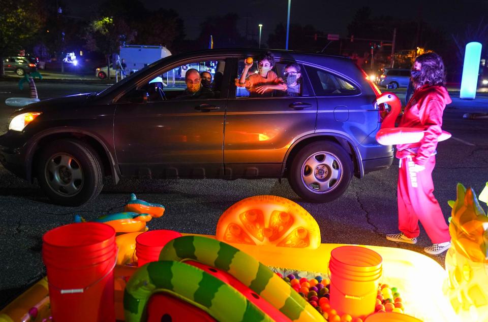 Families attend a drive-through pool party event to promote Jeff Kinney's latest kids book, "Diary of A Wimpy Kid: The Deep End" on Oct. 26. in Silver Spring, Maryland.