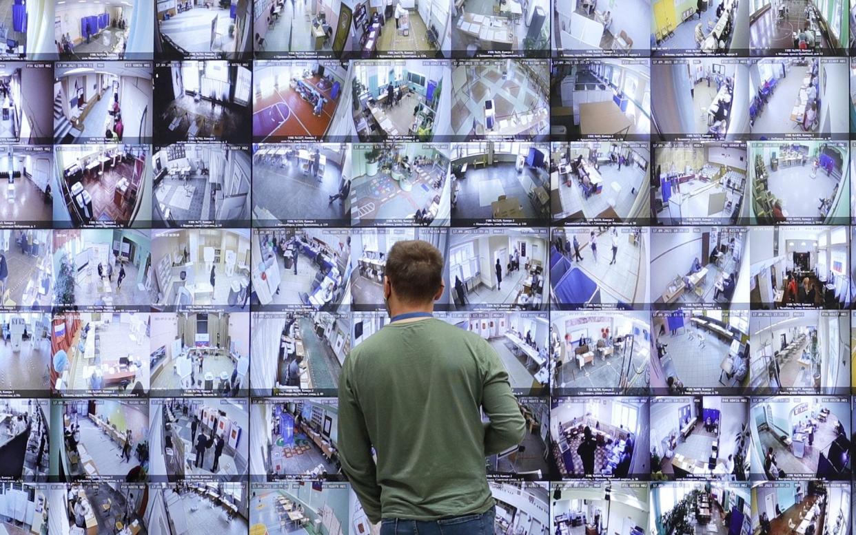 A man looks at a screen broadcasting the voting in the 2021 Russian parliamentary election, at the information center of the Russian Central Election Commission - Mikhail Japaridze/TASS