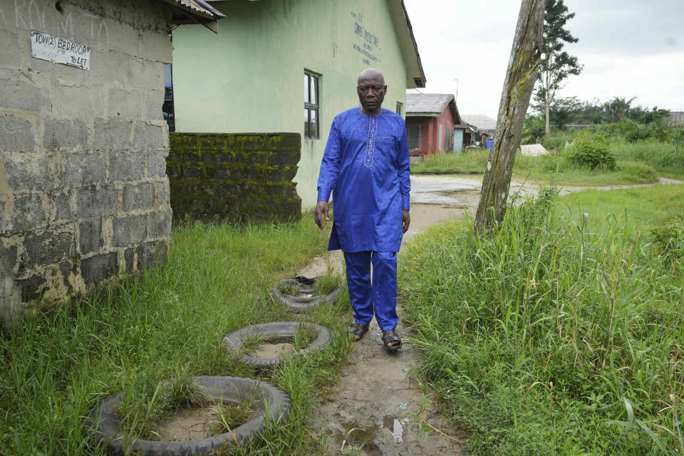 Patrick Aganyebi, a maintenance operator aboard the Trinity Spirit oil ship, walks through his neighborhood in Igbokoda, Nigeria, on Tuesday, Sept. 6, 2022. Aganyebi says it was by the grace of God that he and two fellow crewmen escaped that night from the Trinity Spirit, a rusting ship anchored 15 miles (24 kilometers) off the coast of Nigeria that pulled crude oil from the ocean floor. (AP Photo/Sunday Alamba)