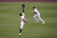 San Diego Padres second baseman Ha-Seong Kim, left, can't reach a hit for a single by Milwaukee Omar Narvaez as center fielder Trent Grisham, right, passes during the fourth inning of a baseball game Wednesday, April 21, 2021, in San Diego. (AP Photo/Gregory Bull)