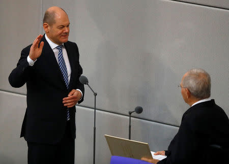 FILE PHOTO: German Finance Minister and vice-chancellor Olaf Scholz is sworn-in by Parliament President Wolfgang Schaeuble in Germany's lower house of parliament Bundestag in Berlin, Germany, March 14, 2018. REUTERS/Kai Pfaffenbach/File Photo