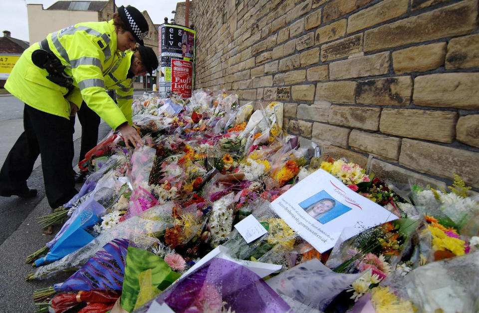 Hundred of floral tributes at the scene of the murder of Pc Sharon Beshenivsky, Sunday November 27, 2005. Detectives were today questioning a a 19-year-old man over the murder of Pc Beshenivsky and the attempted murder of her colleague Pc Teresa Milburn. Yusuf Jama - one of three men police named as suspects earlier this week - was arrested in Birmingham, West Yorkshire Police said. See PA Story POLICE Officer. PRESS ASSOCIATION Photo. Photo credit should read: John Giles/PA.