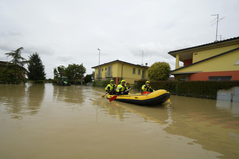 Rescuers use a dinghy on flooded road in Lugo, Italy, Thursday, May 18, 2023. Exceptional rains Wednesday in a drought-struck region of northern Italy swelled rivers over their banks, killing at least eight people, forcing the evacuation of thousands and prompting officials to warn that Italy needs a national plan to combat climate change-induced flooding. (AP Photo/Luca Bruno)