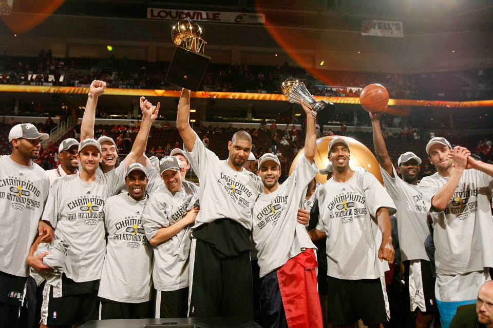 CLEVELAND - JUNE 14: The San Antonio Spurs celebrate with the Larry O'Brien NBA Championship Trophy after their 83-82 win against the Cleveland Cavaliers in Game Four of the NBA Finals at the Quicken Loans Arena on June 14, 2007 in Cleveland, Ohio.&nbsp;