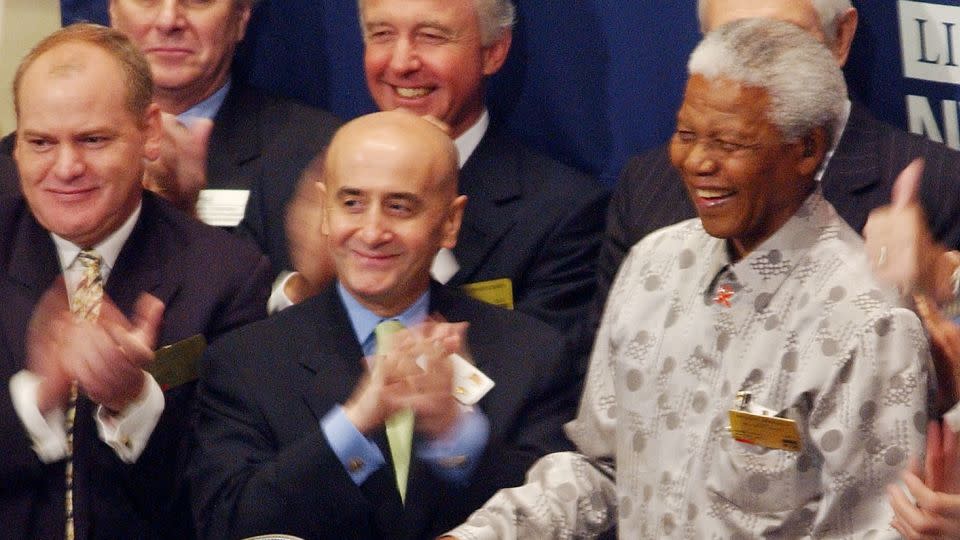 Former South African President Nelson Mandela (R) rings ringing the opening bell at the New York Stock Exchange May 9, 2002 in New York as NYSE Chairman Richard Grasso (C) applauds. - Henny Ray Abrams/AFP/Getty Images
