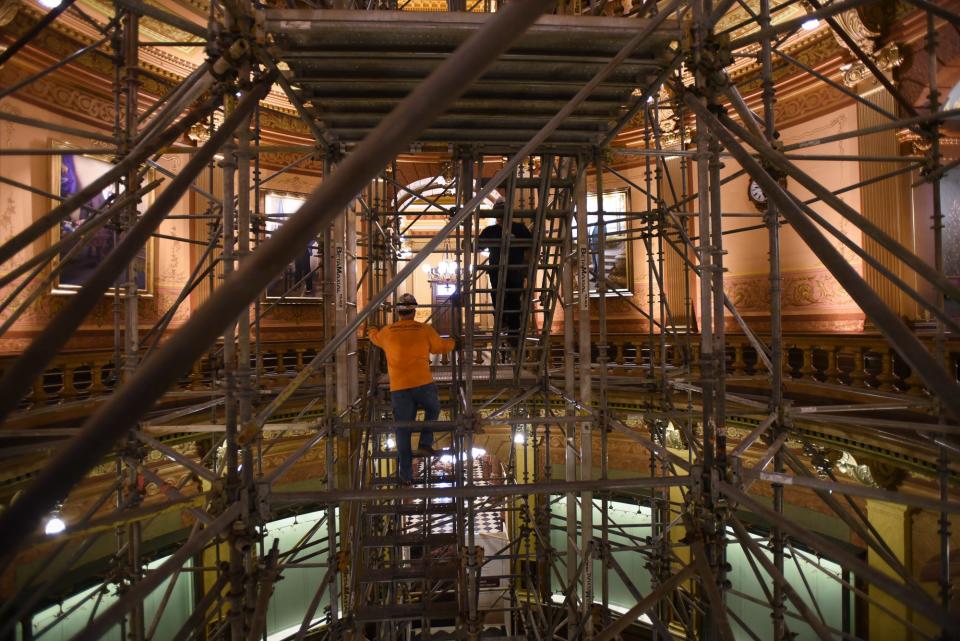 Workers climb the inner stairs of the scaffolding currently under construction in the Capitol rotunda Tuesday, June 27, 2023. The project began June 6 and is expected be complete near the end of July. Once fully erected, it will stand about 160 feet tall rising from the glass floor of the Capitol to the top of the inner dome, allowing experts to examine and begin restoration work on the historical paintings above.