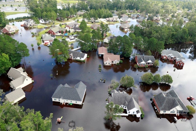 FILE PHOTO: Houses sit in floodwater caused by Hurricane Florence, in this aerial picture, in Lumberton, North Carolina, U.S. September 17, 2018. REUTERS/Jason Miczek/File Photo