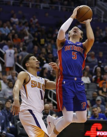 Mar 21, 2019; Phoenix, AZ, USA; Detroit Pistons guard Luke Kennard (5) gets fouled by Phoenix Suns guard Devin Booker (1) in the second half during an NBA basketball game at Talking Stick Resort Arena. Mandatory Credit: Rick Scuteri-USA TODAY Sports