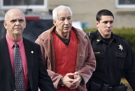 Convicted child molester Jerry Sandusky (C), a former assistant football coach at Penn State University, leaves after his appeal hearing at the Centre County Courthouse in Bellefonte, Pennsylvania October 29, 2015. REUTERS/Pat Little