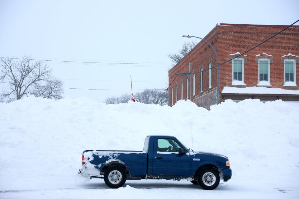 A mound of snow sits in the street as a snowy and freezing cold weather system passes through Adair, Iowa, on Jan. 13, 2024. The weather system is bringing snowfall and subzero temperatures to Iowa as caucusgoers prepare for the Republican presidential caucuses on Jan. 15.